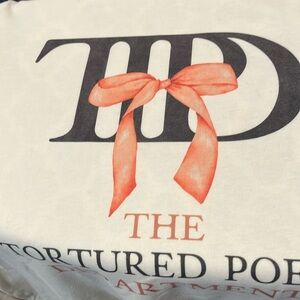 Taylor Swift T-shirt The Tortured Pet Department in cream color. Sz Lg.